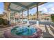 Relaxing hot tub with a covered seating area, surrounded by tropical landscaping and resort buildings at 5300 S Atlantic Ave # 5-206, New Smyrna Beach, FL 32169