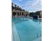 Expansive outdoor pool with clear blue water, and a covered lounging area at 5300 S Atlantic Ave # 5-206, New Smyrna Beach, FL 32169