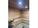 A private sauna boasts wood paneling, recessed lighting, and traditional bucket and ladle at 5300 S Atlantic Ave # 5-206, New Smyrna Beach, FL 32169