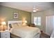 Bright bedroom with a queen-size bed and neutral decor at 5300 S Atlantic Ave # 8-302, New Smyrna Beach, FL 32169