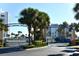 Community entrance with palm trees and blue metal gate at 5300 S Atlantic Ave # 8-302, New Smyrna Beach, FL 32169