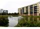 Building beside a pond with a water fountain, showcasing landscaping and serene atmosphere at 5300 S Atlantic Ave # 8-302, New Smyrna Beach, FL 32169