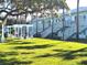 Light teal building with multiple units, stairs, and a grassy courtyard at 541 S Peninsula Ave # A03, New Smyrna Beach, FL 32169