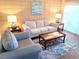 Living room with sofa, armchair, and coffee table at 541 S Peninsula Ave # A03, New Smyrna Beach, FL 32169