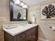 Bathroom with vanity, mirror, and decorative wallpaper at 5499 S Atlantic Ave # 904, New Smyrna Beach, FL 32169