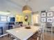 Bright dining room with white table and wicker chairs at 5499 S Atlantic Ave # 904, New Smyrna Beach, FL 32169