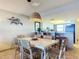 Dining area with white table and wicker chairs at 5499 S Atlantic Ave # 904, New Smyrna Beach, FL 32169