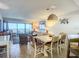 Dining area with white table, wicker chairs, and ocean view at 5499 S Atlantic Ave # 904, New Smyrna Beach, FL 32169