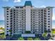 Oceanfront building, multiple floors, balconies, and parking at 5499 S Atlantic Ave # 904, New Smyrna Beach, FL 32169