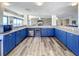 Community kitchen with blue cabinets and island at 5499 S Atlantic Ave # 904, New Smyrna Beach, FL 32169