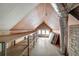 Unfinished attic with shelving and window for light at 608 Magnolia St, New Smyrna Beach, FL 32168