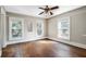 Well-lit bedroom with hardwood floors and ceiling fan at 608 Magnolia St, New Smyrna Beach, FL 32168