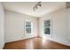 Well-lit bedroom with hardwood floors and two windows at 608 Magnolia St, New Smyrna Beach, FL 32168