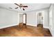 Hardwood floors and ceiling fan in this comfortable bedroom at 608 Magnolia St, New Smyrna Beach, FL 32168