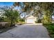 Single-car detached garage with a spacious driveway in front at 608 Magnolia St, New Smyrna Beach, FL 32168