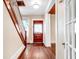 Bright entryway with hardwood floors, staircase, and wooden door at 608 Magnolia St, New Smyrna Beach, FL 32168