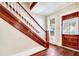 Classic entryway with hardwood floors and wooden staircase at 608 Magnolia St, New Smyrna Beach, FL 32168