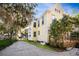 Side view of a charming yellow house with a well-maintained yard at 608 Magnolia St, New Smyrna Beach, FL 32168