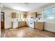 Simple kitchen with wood cabinets and laminate flooring at 608 Magnolia St, New Smyrna Beach, FL 32168