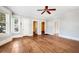 Living room with hardwood floors, multiple doorways, and ceiling fan at 608 Magnolia St, New Smyrna Beach, FL 32168