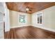 Living room with hardwood floors, wood ceiling, and large windows at 608 Magnolia St, New Smyrna Beach, FL 32168