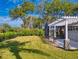 Large backyard with grassy area and pergola at 720 Stonewood Ct, New Smyrna Beach, FL 32168