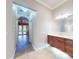 Bathroom with double vanity and view into another room at 720 Stonewood Ct, New Smyrna Beach, FL 32168