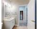 Bright bathroom with white vanity, mirror, and tile flooring at 720 Stonewood Ct, New Smyrna Beach, FL 32168