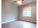 Spacious bedroom with wood-look tile floors and ceiling fan at 720 Stonewood Ct, New Smyrna Beach, FL 32168