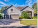 Beautiful two-story home with a three-car garage and landscaped yard at 720 Stonewood Ct, New Smyrna Beach, FL 32168