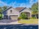 Two-story house with a three-car garage and manicured lawn at 720 Stonewood Ct, New Smyrna Beach, FL 32168