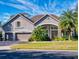 Beautiful two-story home with a three-car garage and landscaped yard at 720 Stonewood Ct, New Smyrna Beach, FL 32168