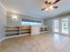 Gathering room with tile floors, built-ins, and French doors at 720 Stonewood Ct, New Smyrna Beach, FL 32168