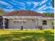 House exterior view showcasing backyard and pergola at 720 Stonewood Ct, New Smyrna Beach, FL 32168