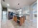 Island kitchen with stainless steel appliances and granite countertops at 720 Stonewood Ct, New Smyrna Beach, FL 32168