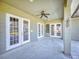 Spacious covered patio with French doors leading to the backyard at 720 Stonewood Ct, New Smyrna Beach, FL 32168