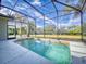 Inviting screened pool with a large backyard at 720 Stonewood Ct, New Smyrna Beach, FL 32168