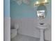 Light blue and white bathroom with pedestal sink at 809 E 7Th Ave, New Smyrna Beach, FL 32169