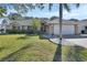 Brick house with a well-maintained lawn and palm trees at 809 E 7Th Ave, New Smyrna Beach, FL 32169