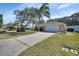 Attractive front yard with lush landscaping and driveway at 809 E 7Th Ave, New Smyrna Beach, FL 32169