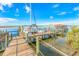 Wooden boat dock with a sailboat and a covered seating area at 81 Alberta Ave, Ponce Inlet, FL 32127