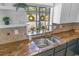 Kitchen detail showcasing granite countertops and a double sink at 81 Alberta Ave, Ponce Inlet, FL 32127