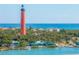 Lighthouse and ocean view with waterfront homes and businesses at 81 Alberta Ave, Ponce Inlet, FL 32127