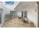 Sunroom with wooden flooring, skylight and seating area at 81 Alberta Ave, Ponce Inlet, FL 32127