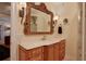 Bathroom features a vanity with a large ornate mirror and an adjacent shower at 817 Hail Ct, Port Orange, FL 32127