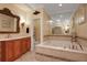 Elegant bathroom with a large soaking tub, double vanity, and separate shower at 817 Hail Ct, Port Orange, FL 32127