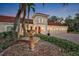 Impressive home entrance with fountain and lush landscaping at 817 Hail Ct, Port Orange, FL 32127