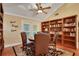 Bright office space with built-in shelves and a charming sitting area at 817 Hail Ct, Port Orange, FL 32127