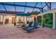 Relaxing covered patio with lounge chairs and umbrella at 817 Hail Ct, Port Orange, FL 32127