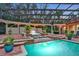 Multi-tiered pool and spa with cascading waterfalls and covered patio at 817 Hail Ct, Port Orange, FL 32127